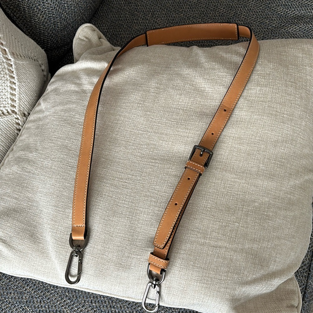 Tumi tan leather strap..